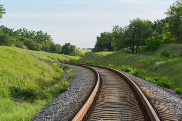 Fototapeta na wymiar The railroad winds between the hills, concept life