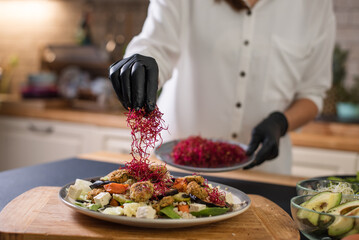 Hands on a Chef preparing salad