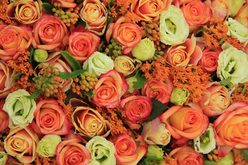 Orange and yellow roses in a bridal bouquet