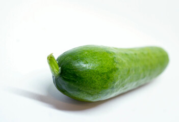 Macro of Single, Green, Ripe Cucumber on White showing Stem Detail