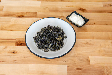 Plate of black rice with aioli sauce