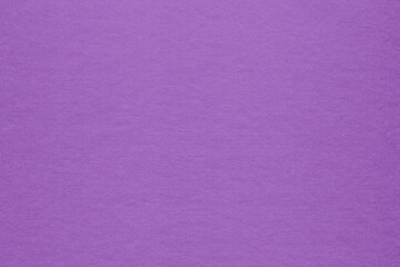 Clean purple retro paper background. Vintage violet cardboard texture. Grunge paper for drawing. Simple blank fabric pattern.
