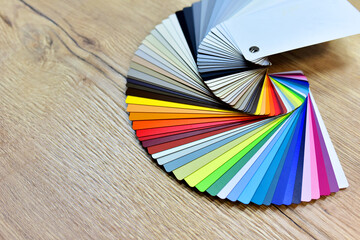 Color palette swatches. Palette of different colors and shades on wood background. Color catalog...
