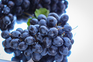 Blue grapes on a clay plate