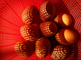 close up of eggs in the red basket