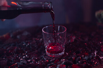 wine bottle filling glass on ground background