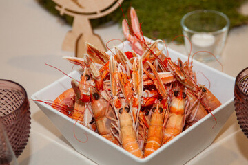 crawfish cooked in white square porcelain platter on wedding banquet