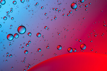 Blue and red bubbles. Abstract background. Bubble oil on water. Macro-photography.
