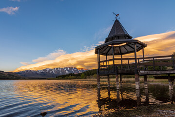 Colorful lenticular clouds over the lake during sunset in Esquel, Patagonia, Argentina