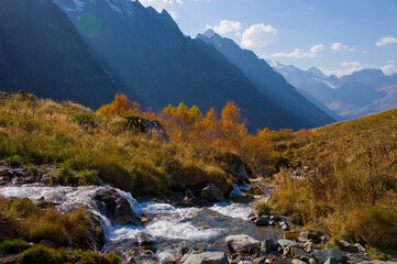 View of the mountains and the stream in the Dombai-Ulgen gorge. 