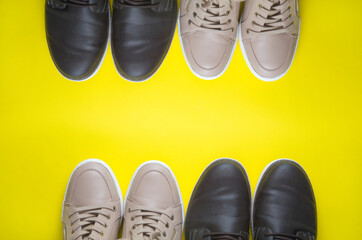 Modern Beige and Brown Leather Shoes on Yellow Background Viewed from Above