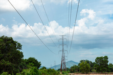 Electricity transmission line with green tree nature, Green conservative energy, Energy be friendly with environment concept, Power distribution pylon system to rural community and countryside