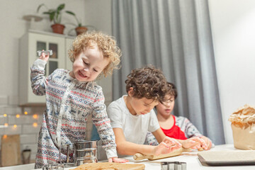 Fototapeta premium happy family funny kids are preparing the dough, bake cookies in the kitchen