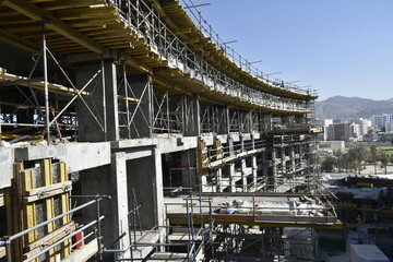 scaffolding in construction works. Tower crane in a new civil construction site Building in Oman. Oman city. Muscat, Oman