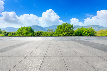 Empty square floor and green mountain background.