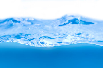 Water droplets and blue waves on a white background
