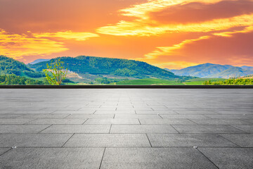 Empty square floor and green mountain background.