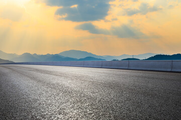 Asphalt road and mountain at sunset.Road and mountain background.