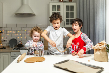 happy family funny kids are preparing the dough, bake cookies in the kitchen