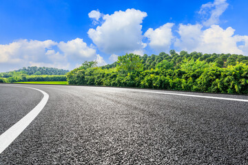 Asphalt road and green mountain under blue sky.Road and mountain background.