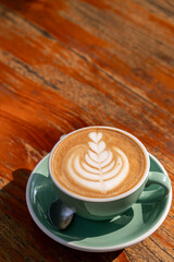 latte coffee cup with latte art on table view from top view.