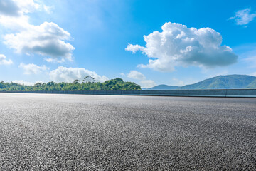Asphalt road and green mountain under blue sky.Road and mountain background.