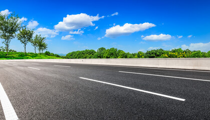 Asphalt road and green mountain under blue sky.Road and mountain background.