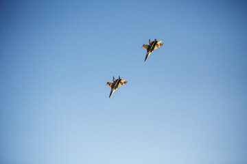 Two military fighter jets show teamwork in the air. 