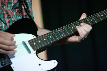 Fototapeta premium Artist guitarist, man, woman, on stage during a show.