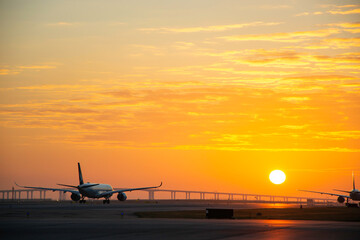 Hong Kong, 28 Dec,2020, Cathay Pacific airplane taxiing to runway with sunset background