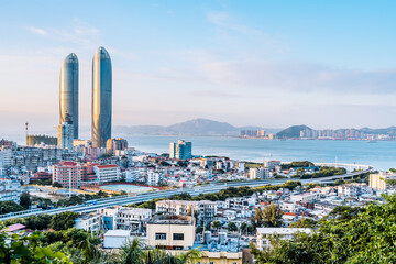 Coastline scenery of twin towers and Yanwu bridge in Xiamen, Fujian, China