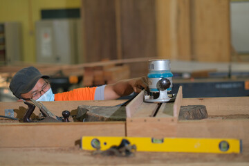 Front view photo of focused professional hardwood worker making slab table use electronic...