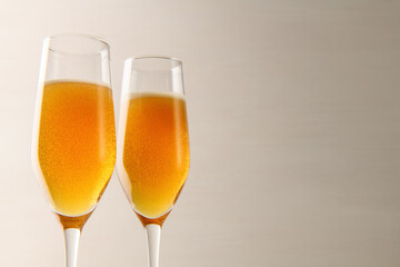 Two glasses of champagne with bubbles on a gray background. New year and Christmas background. Valentine's Day