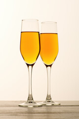 Two glasses of champagne, wine on gray background. Alcoholic drink: champagne, beer, white wine. New year and Christmas background. Valentine's Day. Vertical
