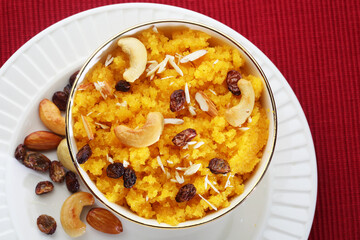 Plain or Saffron flavoured Semolina / Soji Halwa also known as Sweet Rava Sheera OR Shira - Indian festival sweet garnished with dry fruits. Served in a plate or Bowl