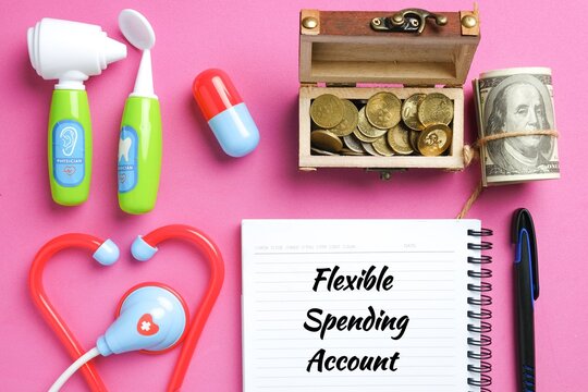 A Picture Of Medical Toy, Gold Chest, Fake Money And Flexible Spending Account On Note Book. It Is Also Known As A Flexible Spending Arrangement Is One Of A Number Of Tax-advantage.