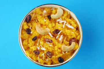 Plain or Saffron flavoured Semolina / Soji Halwa also known as Sweet Rava Sheera OR Shira - Indian festival sweet garnished with dry fruits. Served in a plate or Bowl
