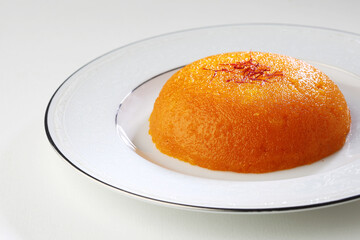 Plain or Saffron flavoured Semolina / Soji Halwa also known as Sweet Rava Sheera OR Shira - Indian festival sweet garnished with dry fruits. Served in a plate or Bowl