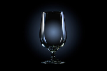 Empty glass for whiskey, brandy or bourbon on a black background with copy space.
