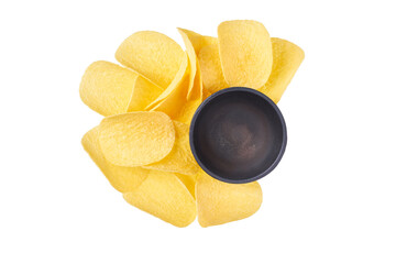 little pile of crispy potato chips and empty gravy boat isolated on a white background, top view.