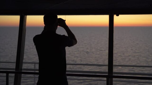 Silhouette of navy captain looking seascape sunset with a binocular, cinematic