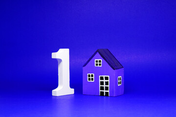 First House , Number 1 ( one ) with wooden home Isolated blue  Background and Copy Space - House property  Business building and finance loan Concept