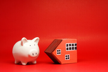 Fund , Investment , Saving money concept : Mockup White Piggy bank and House on red background with...