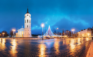 Fototapeta na wymiar Vilnius, Lithuania. Christmas Tree On Background Bell Tower Belfry Of Vilnius Cathedral At Cathedral Square In Evening New Year Christmas Xmas Illuminations. Unesco World Heritage Site
