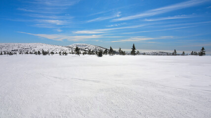 Snowy mountain peak with freeze icy snow cover. Amazing flat wintry landscape.
