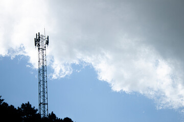 Silhouette antennas on blue sky.