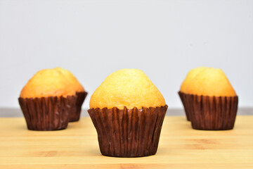 Close up in the center. Homemade mini muffins on slate table.