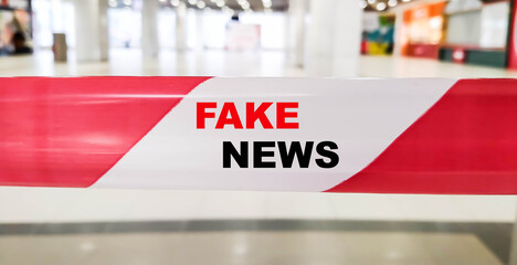 FAKE NEWS on the bounding red tape in the event room.