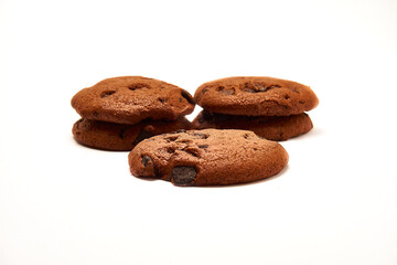 Delicious cookies with cocoa powder and droplets of chocolate icing on white background.