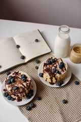 Delicious pancakes with blueberries, chocolate and a bottle of milk. Healthy eating. Morning tasty homemade breakfast, stack of fluffy and delicious sugar free pancakes. White background.